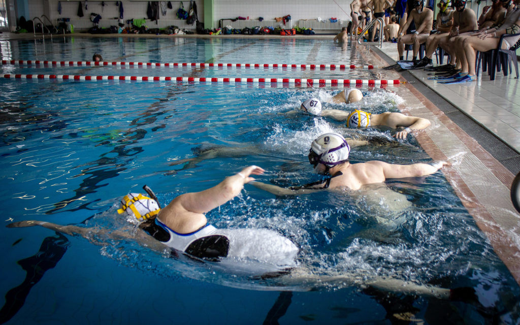 Underwater rugby players in action